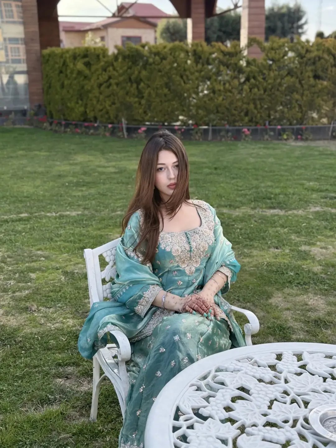 Teal ethnic wear in a garden setting